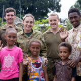 Soldiers standing with civilians on Solomon Islands.