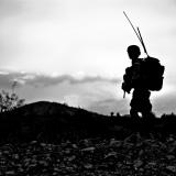 A soldier standing on a cliff.