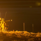 Personnel launch a live Bolide missile at night.