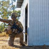 A US soldier kneeling while on training exercise.