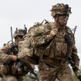 US Army soldiers walking in bushland.