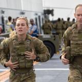 Australian Army soldiers from the 1st Battalion, Royal Australian Regiment, conduct battle physical training on the flight deck of HMAS Adelaide during Indo-Pacific Endeavour 2022.