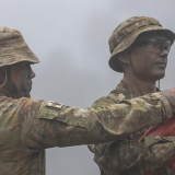 Instructor explains to recruits the drills for the bayonet assault course.