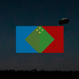 The fictitious Olvana flag on a background of soldiers in parachutes.