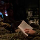 Australian Army soldiers from Task Group Taji 3 relax aboard a Royal Australian Air Force C-130J aircraft while flying to Iraq.