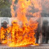 Australian Army soldiers, including Military Police, defend against a flame-thrower scenario as part of a Population Protection Control course.