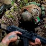 An Australian Army soldier provides instruction to an Armed Forces of Ukraine recruit during battle inoculation training.