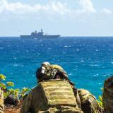 Australian Army Soldiers post security during an amphibious raid for a multinational littoral operations exercise.