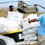 Residents of Aniwa Island, Vanuatu, unload Australian Aid goods and cargo from an Australian Army CH-47 Chinook helicopter during Operation Vanuatu Assist 2023.