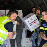 Australian Defence Force and Australian Disaster Assistance Response Team members unload Australian Aid stores from a RAAF C-27J Spartan aircraft on the flight line of Wapenamanda Airport, Papua New Guinea.