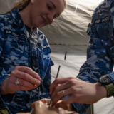 Australian Army medical workers practice on a dummy.