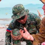 Australian Army soldier from the 1st Combat Engineer Regiment and members of the Philippine Marine Corps Force Reconnaissance Company prepare an explosive time fuse during Joint Australian Training Team – Philippines (JATT-P) program at Marine Base Ternate, Philippines.