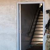 Australian Army soldiers conduct an urban breach and assault on an exercise.