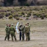 Australian Army soldiers gather round the instructor during the train-the-trainer course.