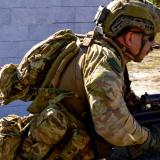 An Australian Army soldier runs to take up a firing position during an assault on an 'enemy' defensive position during an exercise.