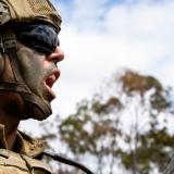 An Australian Army soldier delivers orders during a live-fire fire mission.