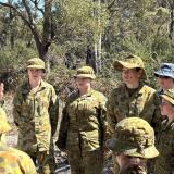 A retired general engages with Army and Air Force cadets during a field exercise.