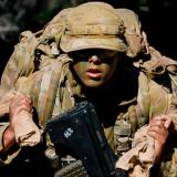 An Australian Army Staff Cadet carrying sandbags.