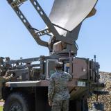 Australian Army Signallers showing a United States Marine Corps Lance Corporal a Medium Satellite Communications (SATCOM) Terminal.