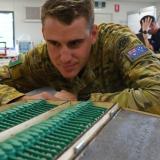 An Australian Army combat engineer with 3D-printed replica PFM-1 butterfly mines.
