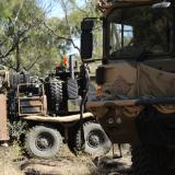 An Australian Army soldier leads an Australian Army HX77 to position.
