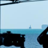 A Boatswain's Mate observes JS Yudachi navigating the Malacca Strait while in company with HMAS Warramunga.