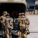 Members of the 4th Health Battalion load a simulated casualty during aeromedical evacuation training.