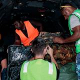 Royal Australian Air Force personnel work with the Papua New Guinea Defence Force to load a C-27J Spartan aircraft.