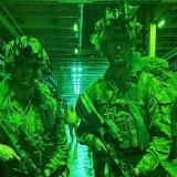 Soldiers illuminated by night vision.