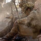 Soldiers sitting amongst the dust.