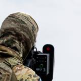 An Australian Army soldier takes aim to jam a drone mid-flight.