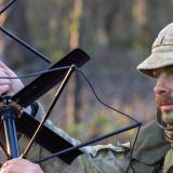 An Australian signaller sets up a satellite radio antenna.