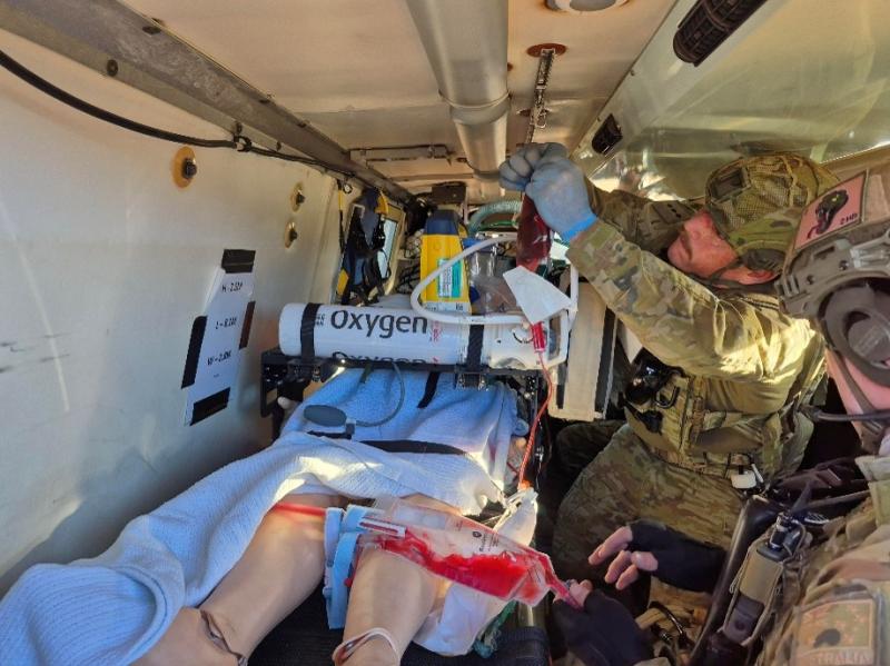 Soldiers undertaking critical care patient transfer