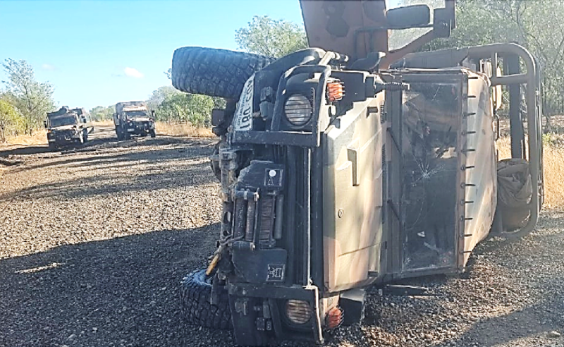 The G Wagon post rollover. Note the damaged road in mottled shade ahead of the two other vehicles.